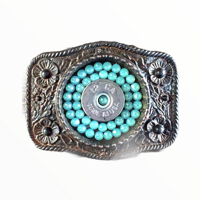 Antiqued silver belt buckle with turquoise crystals and a bullet shell in the center.